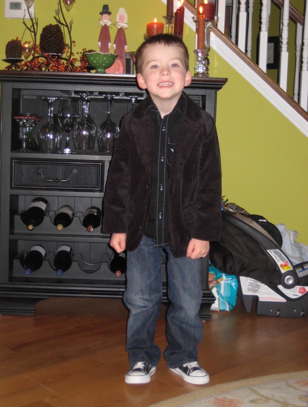 Jimmy Gracey as a young boy, dressed up and smiling at home